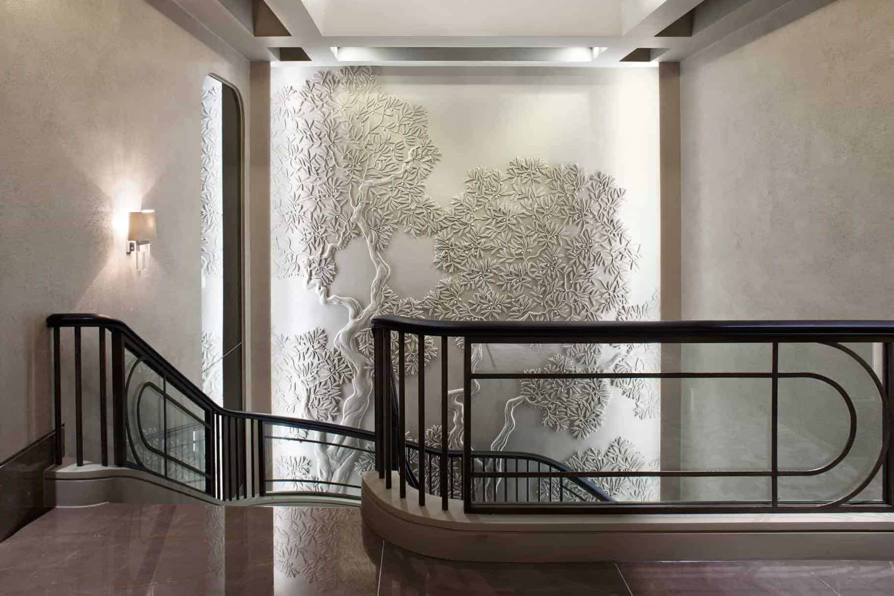 Olive tree bas-relief in residential stairwell area