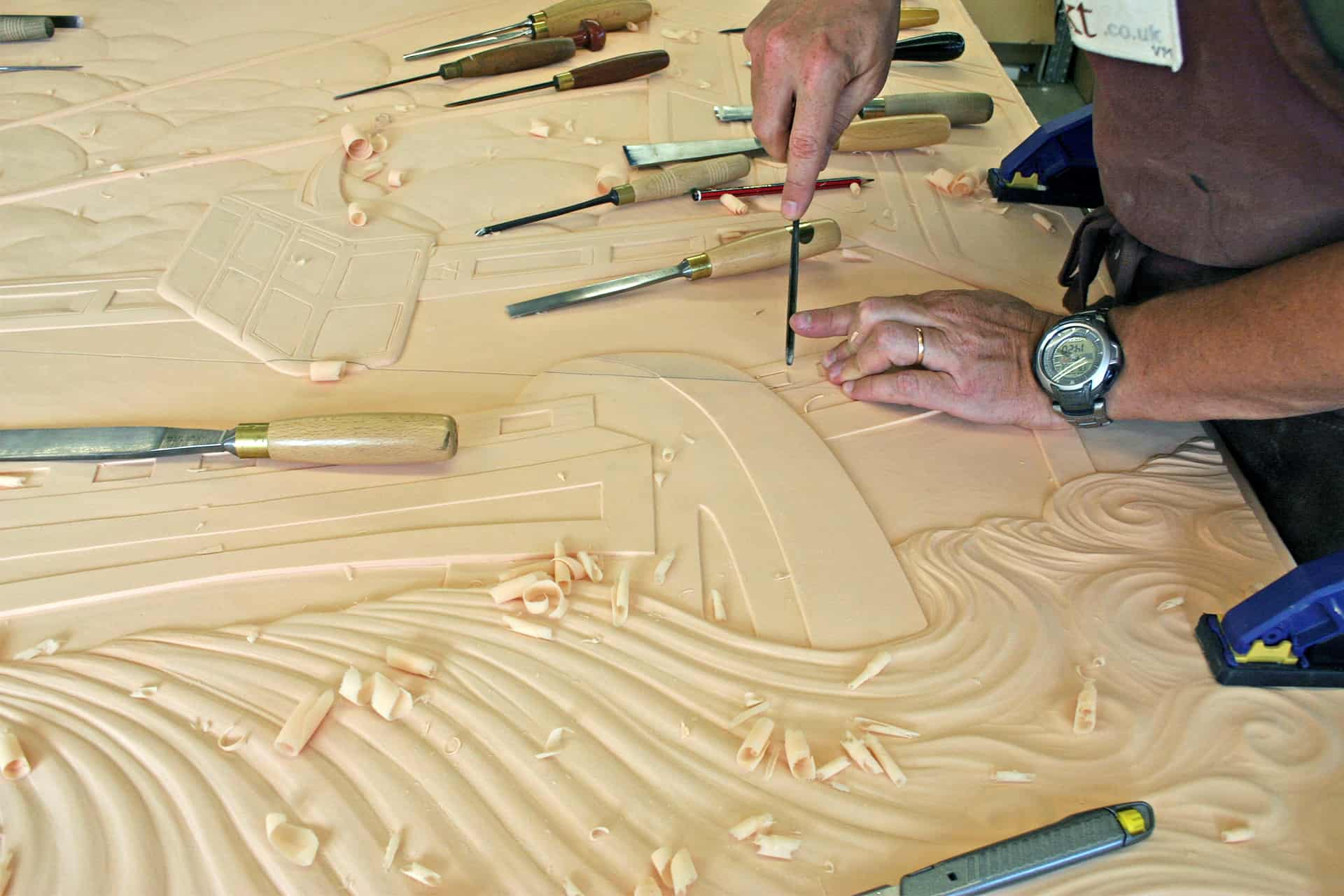 Work in progress on hand carved bas-relief in Art Deco style. Photo by DKT Artworks.