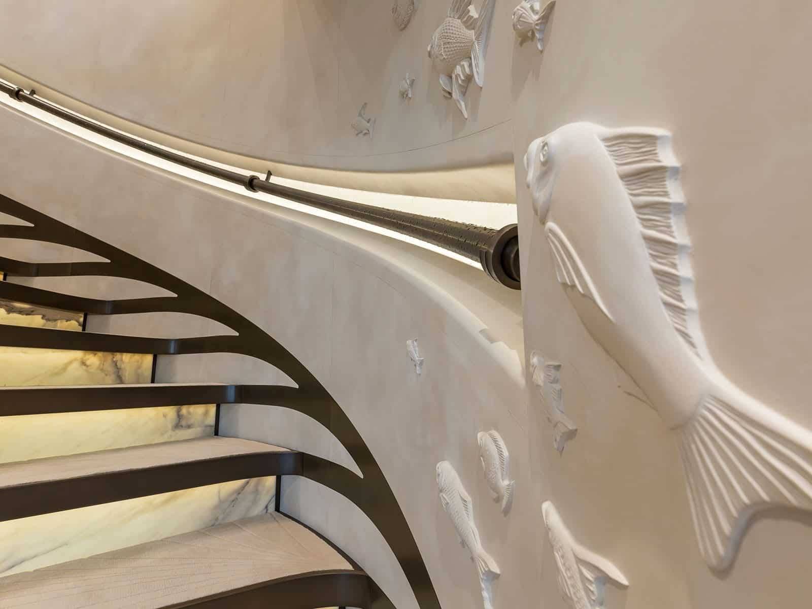 Bespoke decoration for main stairwell, including balustrade and fish themed bas-relief | DESIGN: Nuvolari Lenard | PHOTO: © Georges Ajouri / The World of Yachts