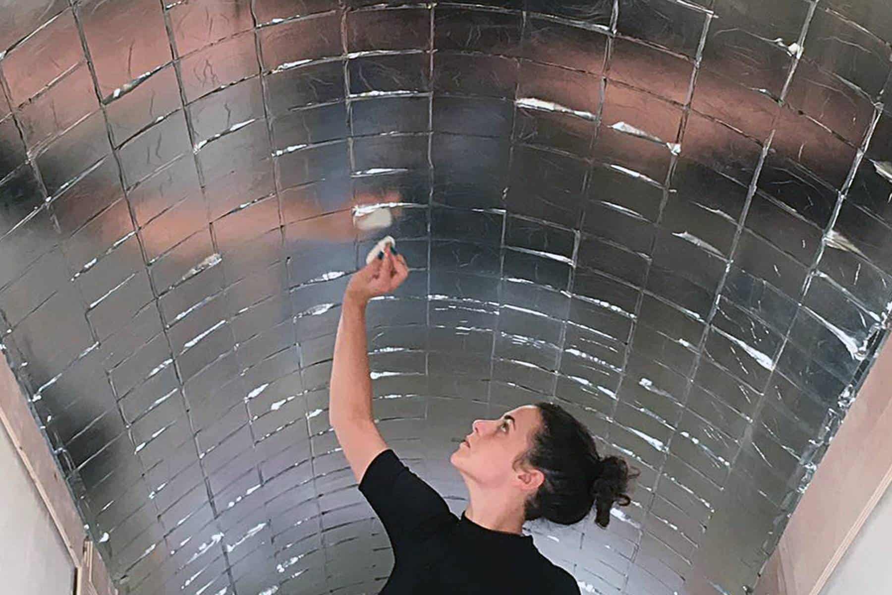 Artist gilding arched ceiling